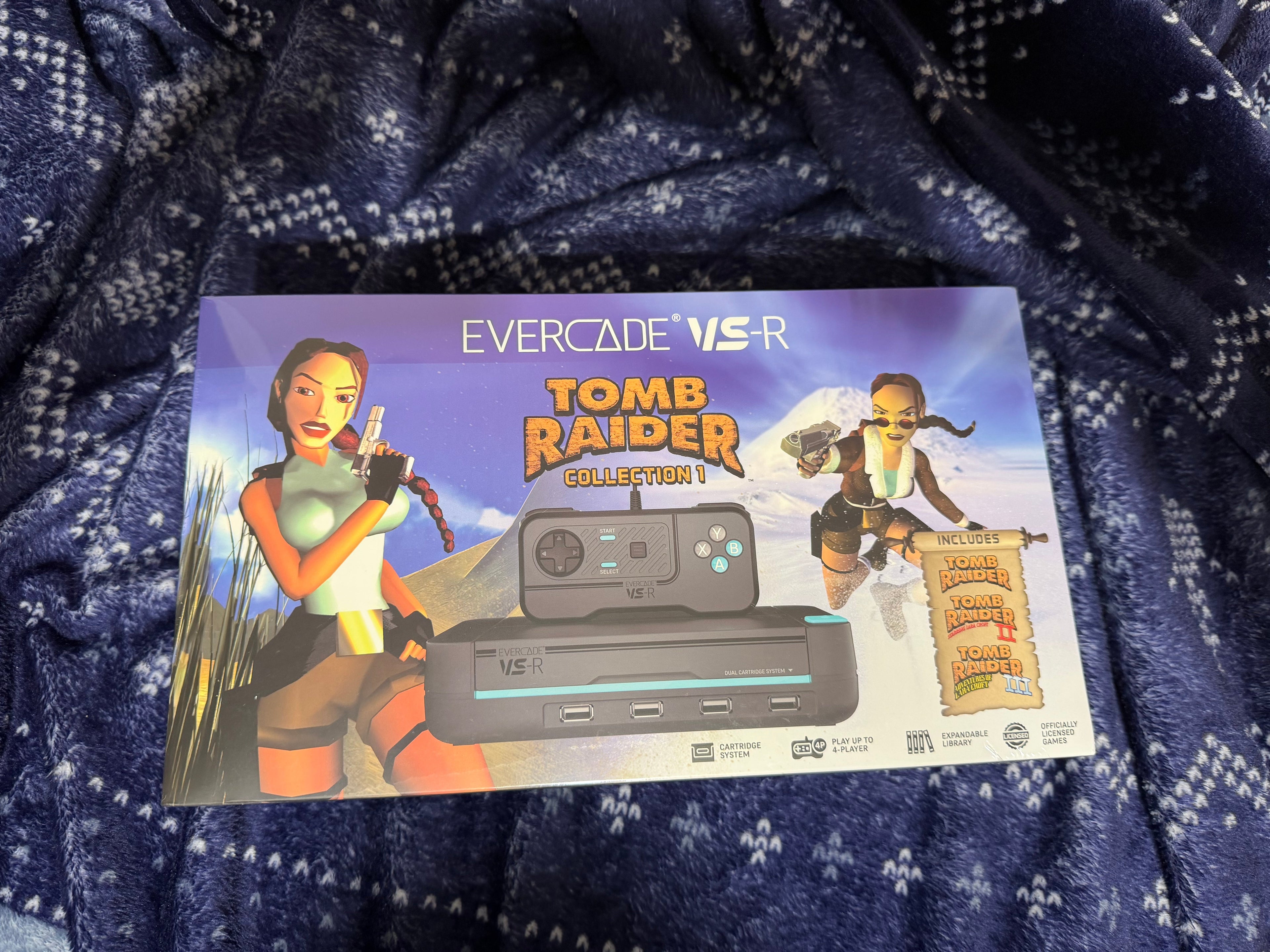 Evercade VS-R Tomb Raider Collection packaging on a textured blue fabric background